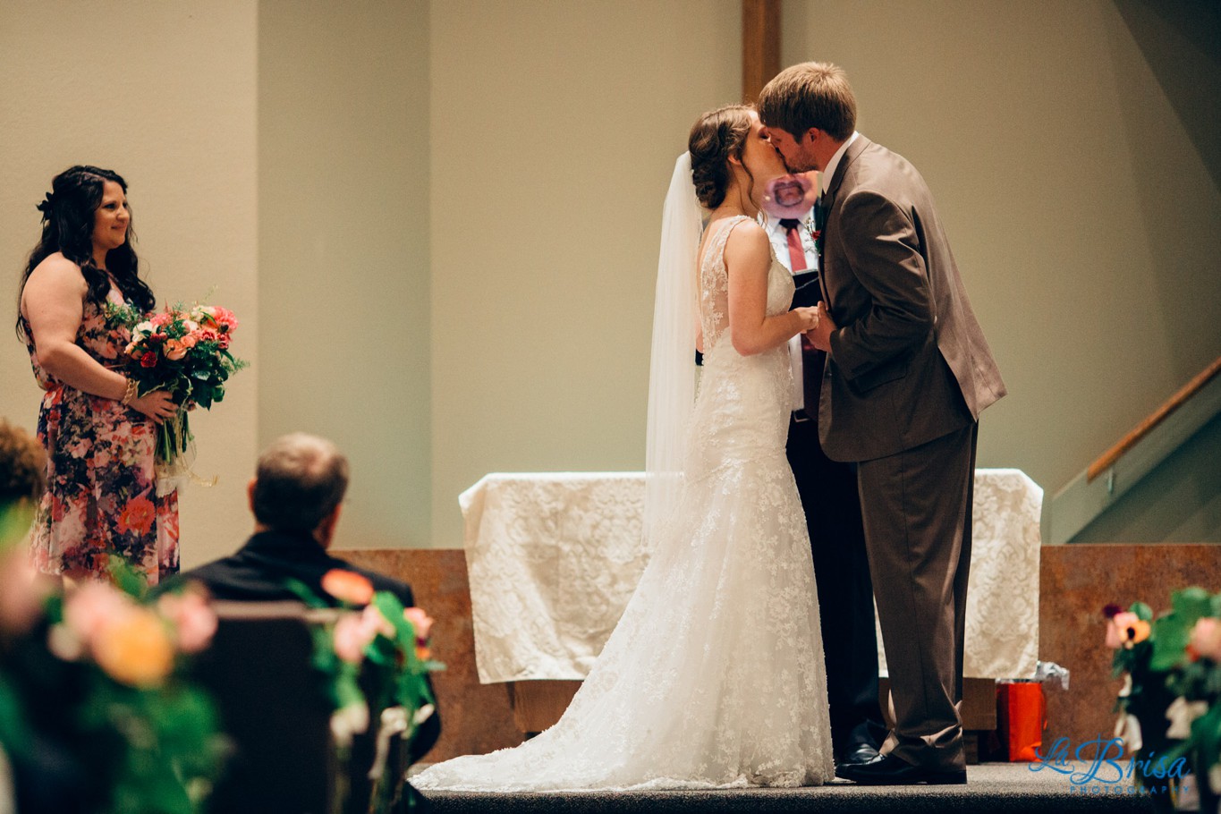 Bride and Groom's first kiss wedding ceremony Journey Christian Church Wayne Nebraska