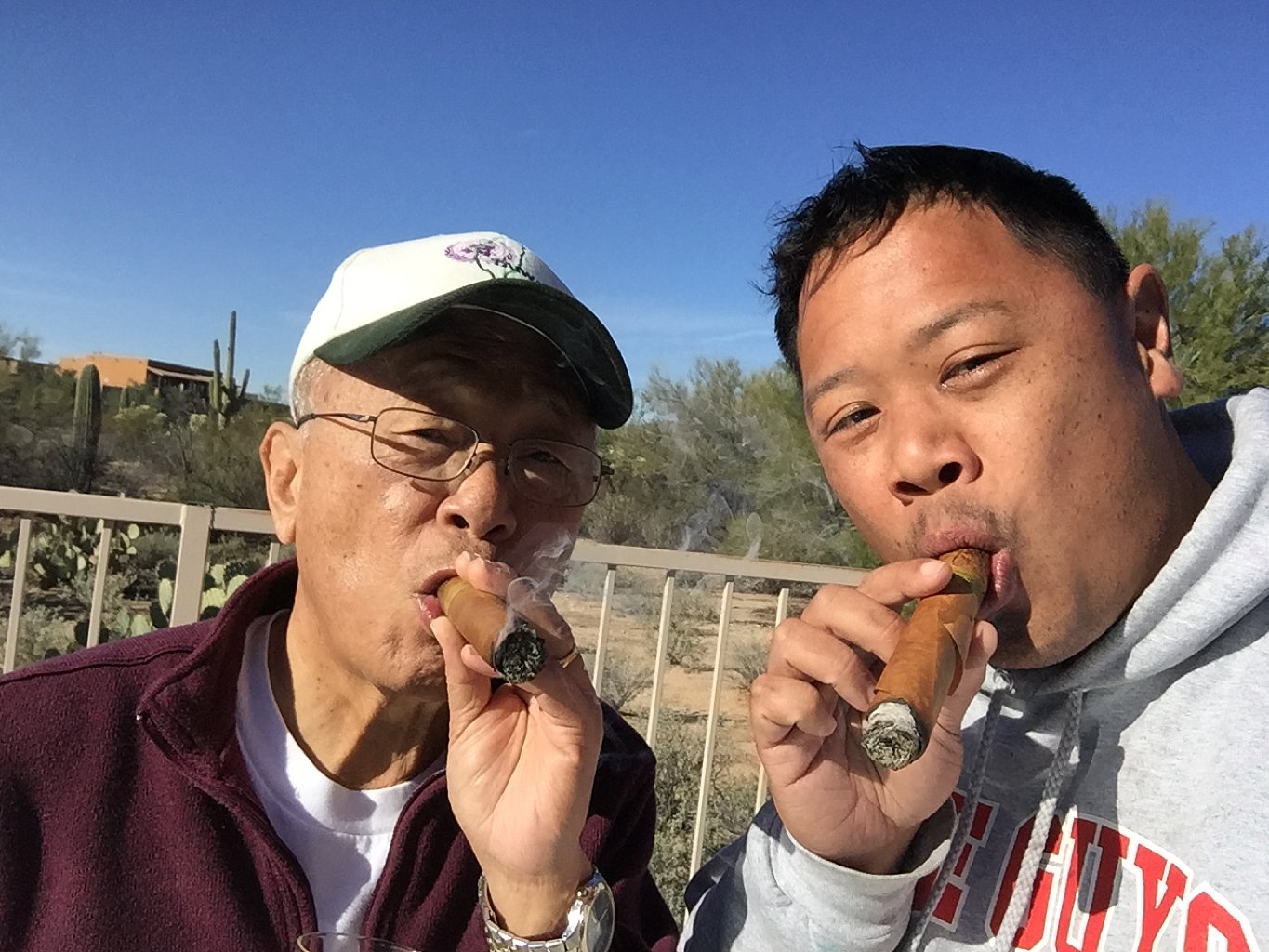 father son smoking cigars