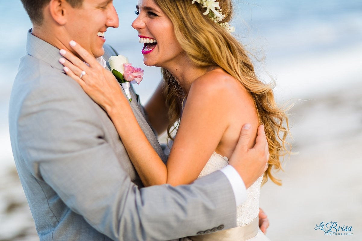 bride groom laughing flower crown beach wedding