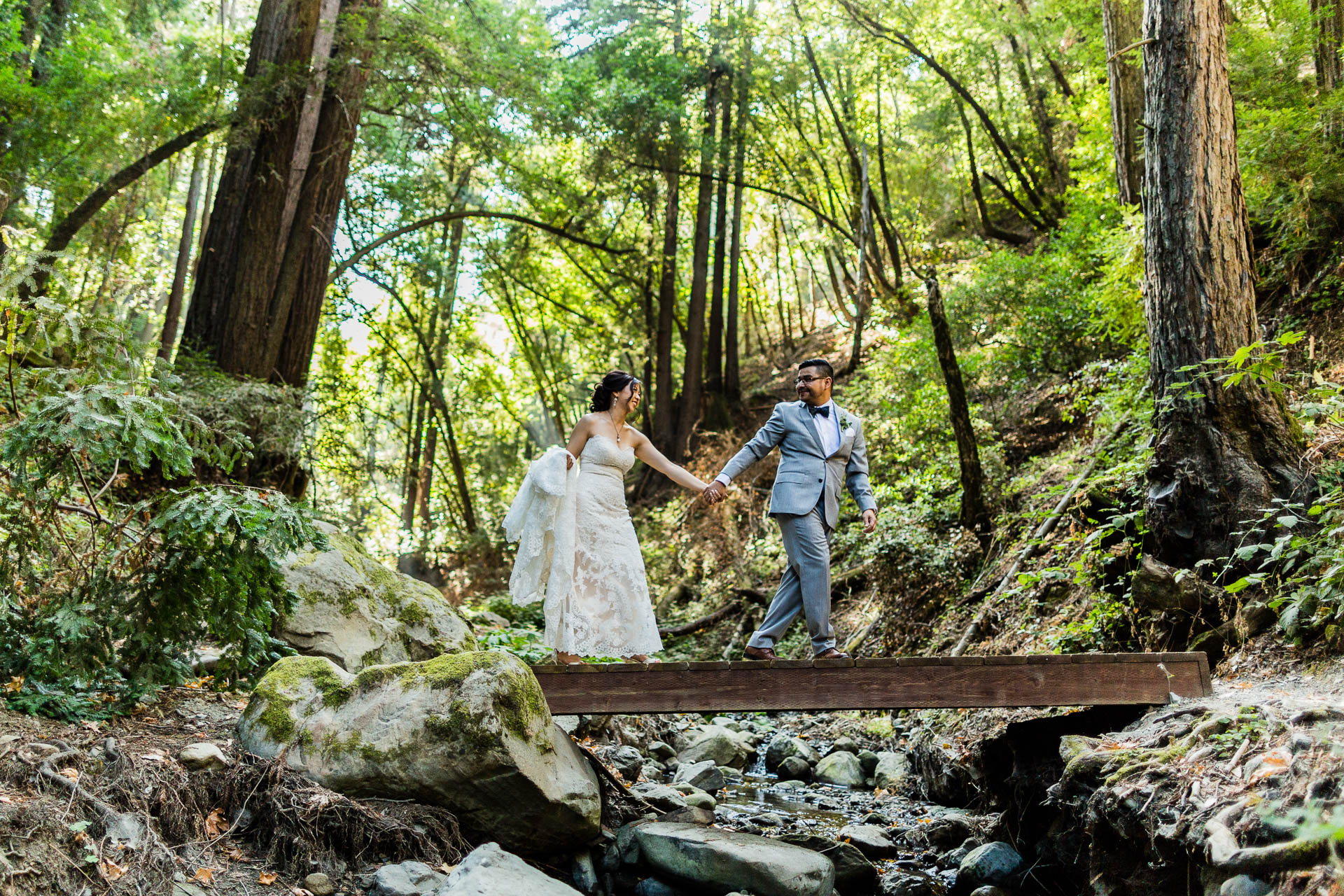 Walking across trail bridge bride groom Saratoga California