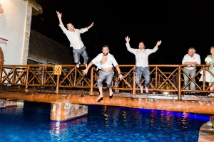 jumping into pool Now Sapphire Riviera Cancun wedding